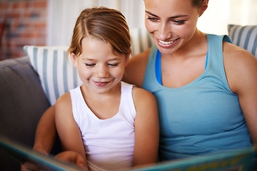 Image showing Home, book and mother with kid, girl or hobby with smile or bonding together in a living room. Family, apartment or mama with daughter or child development with reading or storytelling with education