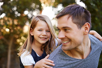 Image showing Piggy back, park and father with girl, kid or holiday with fun, smile or vacation with happiness. Single parent, joy or dad carrying child with girl or sunshine with weekend break or bonding together