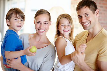 Image showing Portrait, smile and family in home for love, bonding and siblings together with fruit. Face, happy parents and kids in living room for connection with mother, father or children eating apple in house