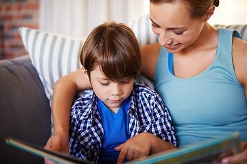 Image showing Home, book and mother with kid, boy or hobby with activity or bonding together in lounge. Family, apartment or mama with son, creative or child development with reading or storytelling with education