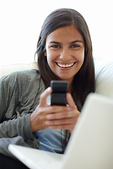 Image showing Portrait, cellphone and laptop for female person, texting and couch at home for relax. Technology, social media and computer or streaming or online, mobile networking or communication on sofa