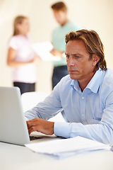 Image showing Laptop, serious and man copywriting in office, working and thinking for ideas, creative and table. Technology, employee and male person typing on keyboard, online and connection to internet in job