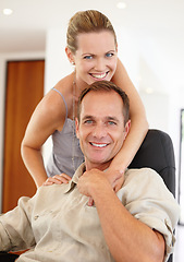 Image showing Care, portrait and couple in hug on chair, love and proud of marriage milestone in home. Happy, embrace and people for relationship achievement, romance and bonding in apartment for commitment