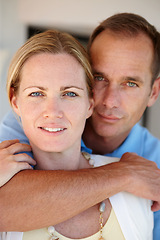 Image showing Home, portrait and couple in hug for care, love and proud of marriage milestone on anniversary. Lounge, embrace and people for relationship achievement, romance and bonding in apartment for support