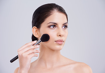 Image showing Woman, makeup and application brush in studio for beauty blush, cosmetics or grey background. Female person, facial contour and treatment transformation for makeover wellness, mockup space or routine