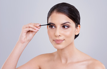 Image showing Makeup, mascara and brush for lashes with woman in studio, beauty and cosmetology on white background. Skin, glow and transformation for makeover, cosmetic product and wand for eyelash with volume