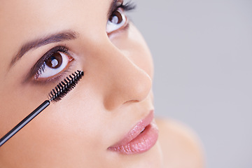 Image showing Eyes, mascara and brush with woman for beauty, lashes and cosmetology on white background. Makeup, glow and transformation for makeover in studio, cosmetic product and wand for eyelash with volume