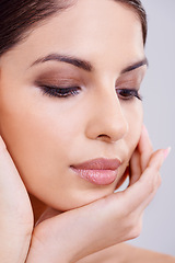 Image showing Woman, face and hand with beauty and skincare, dermatology and eyeshadow for cosmetics isolated on white background. Makeup, transformation and healthy glow for skin, wellness and self care in studio