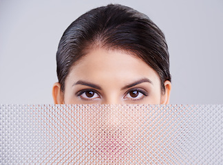 Image showing Woman, face and eyes for makeup in studio with mascara, skincare and eyeshadow. Female model, lashes and aesthetic for cosmetics in beauty parlor with grey background, textured glass and dermatology