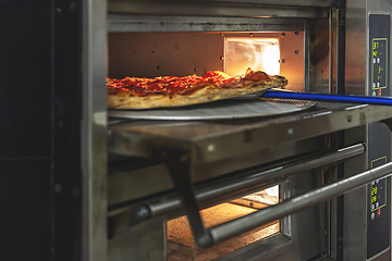 Image showing Delicious pepperoni pizza on a metal peel