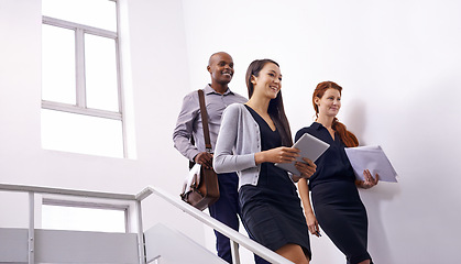 Image showing Office building, stairs and business people walking with tablet, documents or planning for meeting brief. Corporate, coworking and creative team at startup with conversation, chat or communication