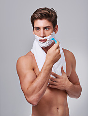 Image showing Razor, shave and man on gray background for wellness, hair removal and beauty treatment in studio. Skincare, dermatology and isolated person with shaving cream for cosmetics, grooming and hygiene