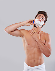 Image showing Man, shave and cream with razor blade for grooming, hygiene or facial treatment on a gray studio background. Handsome and attractive male person or model with creme for skincare or beauty on mockup