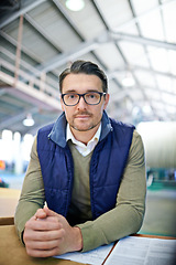 Image showing Portrait, supervisor and businessman in logistics at factory with machines for supply chain. Mature man, warehouse and table with paperwork for stock take in manufacturing and distribution business