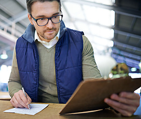 Image showing Manager man, glasses and clipboard in logistics warehouse for inspection or inventory checkup. Male supervisor, writing and label packages in freight factory for shipping or distribution of goods.