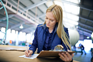 Image showing Business people, writing and reading with inventory checklist for clipboard, storage or supply chain at warehouse. Female person or employee with documents or paperwork for distribution at factory