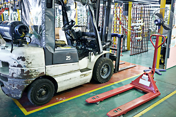 Image showing Factory, warehouse and forklift or industrial vehicle, loading or unloading for delivery with hydraulic pallet. Lifting, heavy load for mobility or hoist, manufacturing machine truck in storage dock