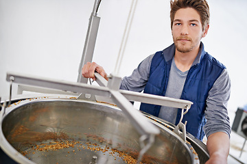 Image showing Brewery, man and hops in machine with manufacturing for craft beer, portrait and production process in factory. Industrial industry, worker or working in distillery with tank for brewing in warehouse