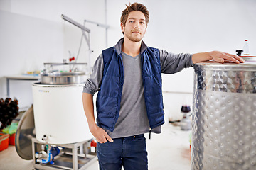 Image showing Brewery, man and portrait by machine with manufacturing for craft beer, alcohol or production process in factory. Industrial metal, worker or pride in distillery with tank for brewing in warehouse