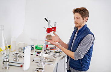 Image showing Man, beer manufacturing and hops in lab, tools at factory or brewery for drink with natural ingredients. Alcohol production, expert or professional in industry with barley, equipment and distillery