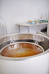 Image showing Brewery, tank or craft beer in machine for production with manufacturing process, wort and alcohol in a keg. Industrial industry, closeup and brewing equipment in factory, warehouse or small business