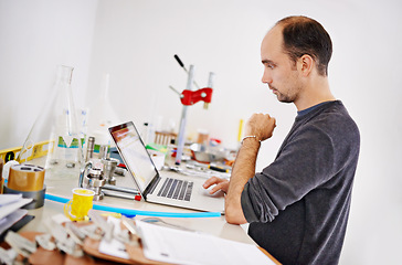 Image showing Man, laptop and equipment in factory, brewery and thinking with ideas, research and development. Person, computer and vision with info on web for alcohol, craft beer and tools on desk in warehouse