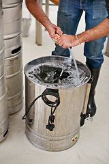 Image showing Brewery, man and hands in tank in factory for cleaning pipes, manufacturing tools or machine. Industrial, worker and washing brewing container for craft beer, alcohol or closeup of production process