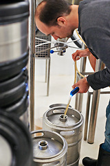 Image showing Brewery, man and pipe in machine with manufacturing for craft beer, alcohol and production process in factory. Industrial industry, worker and working in distillery with tank for brewing in warehouse