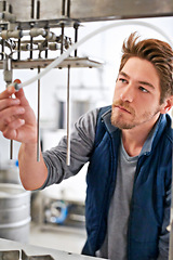 Image showing Brewery, man and pipe in factory with manufacturing for craft beer, alcohol and production process in machine. Industrial industry, worker and working in distillery with tank for brewing in warehouse