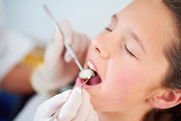 Image showing Girl, kid and mouth inspection at dentist with healthcare tool, consultation and dental equipment for oral health. Expert, child patient and glove hand for teeth cleaning, gingivitis and medical care