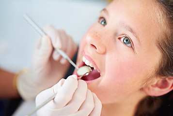 Image showing Young, child and visit dentist with teeth, mirror and mouth for medical dental hygiene consult at hospital. Girl, patient and orthodontist for appointment with tools for treatment of healthy gums