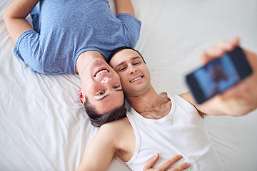 Image showing Phone screen, selfie and gay couple on bed with memory, love or top view bonding at home. LGBTQ, profile picture or people relax in bedroom with smartphone photo for social media, blog or post