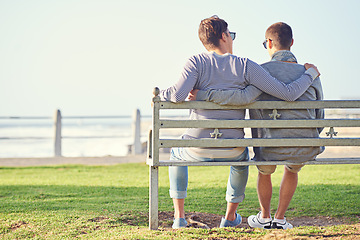 Image showing Couple, park and bench for gay male people, ocean and promenade in nature. LGBT, love and hug or affection for married queer relationship, partner and honeymoon on holiday for bonding or relax