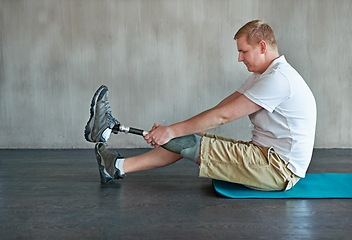 Image showing Training, fitness and person with disability in studio for rehabilitation, exercise and physical therapy. Man, strength and physiotherapy with amputee for workout, health and wellness in gym