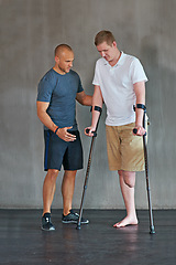 Image showing Physical therapy, crutches and patient with disability to exercise at clinic for recovery, strength and healthcare rehabilitation. Physiotherapist, support and consultation or workout for amputee