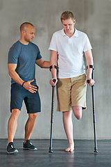 Image showing People, physiotherapy and man with disability for fitness, support and wellness or muscle health in crutches. Physical therapy, physiotherapist and amputee for leg exercise and helping with balance