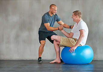 Image showing Physical therapy, amputee and exercise ball with a man with a disability and physio for rehabilitation. Physiotherapy, help and healthcare professional with trainer helping and wellness for mobility