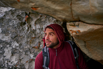 Image showing Man, hiking adventure and rocks in cave with backpack for tough activity, nature and strong health. Male hiker, extreme survival and exercise for fitness with mountain, natural landscape and travel