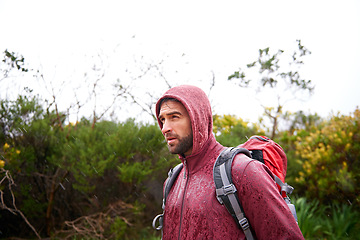 Image showing Extreme, hiking and man in rain, walking and holiday for survival adventure, outdoor and trekking. Water, traveller and male person with backpack in tough environment, rough and destination of Europe