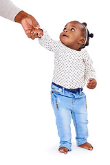 Image showing Baby girl, holding hands and parent support in studio for walking development of child, learning and milestone. Balance, motor skills and coordination for steps on white, background for caring.