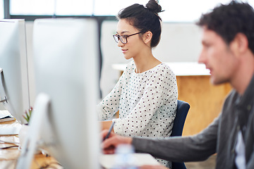 Image showing Woman, man and working at agency with technology for internet, planning and profession. Employees, computer and together for editing in workplace with teamwork, graphic design and writing notes