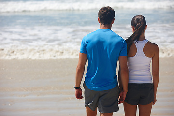 Image showing Back, beach and couple with fitness, waves and training with energy and sunshine with morning routine. Hobby, seaside and man with woman or summer with weekend break and water with cardio or exercise