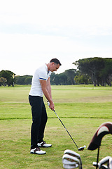 Image showing Man, golfer and playing with club on golf course for game, match or outdoor sport on green grass or field in nature. Male person or player with ball on lawn for competition or swing down fairway