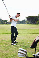 Image showing Man, golfer and swing with club on golf course for game, match or outdoor sport on green grass or field in nature. Male person or player hitting ball on lawn for hole, competition or down the fairway