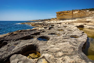 Image showing Crystal clear turquoise water in blue lagoon. St. Peters pool - rocky beach at Malta