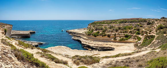 Image showing Crystal clear turquoise water in blue lagoon. St. Peters pool - rocky beach at Malta