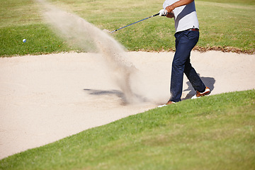 Image showing Man, golfer and hands with swing in sand pit for par, stroke or strike on grass field in nature. Closeup of male person or sport player hitting ball out for point or tough outdoor shot on golf course