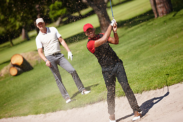 Image showing Man, golfer and friends with club in sand pit for point, score or shot by grass field in nature. Male person, people or sports player hitting ball out of dirt on golf course for outdoor game or match