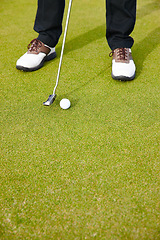 Image showing Feet, club and ball for sports on golf course, training and practice for competition or tournament. Closeup, shoes and grass for outdoor challenge and exercise, low angle and professional athlete