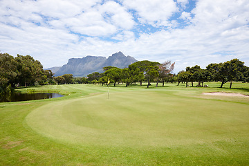 Image showing Grass, landscape and outdoor at golf course with mountain on luxury holiday or vacation. Calm, morning and lawn with turf for sport in woods, forest or nature of park with field and trees in summer